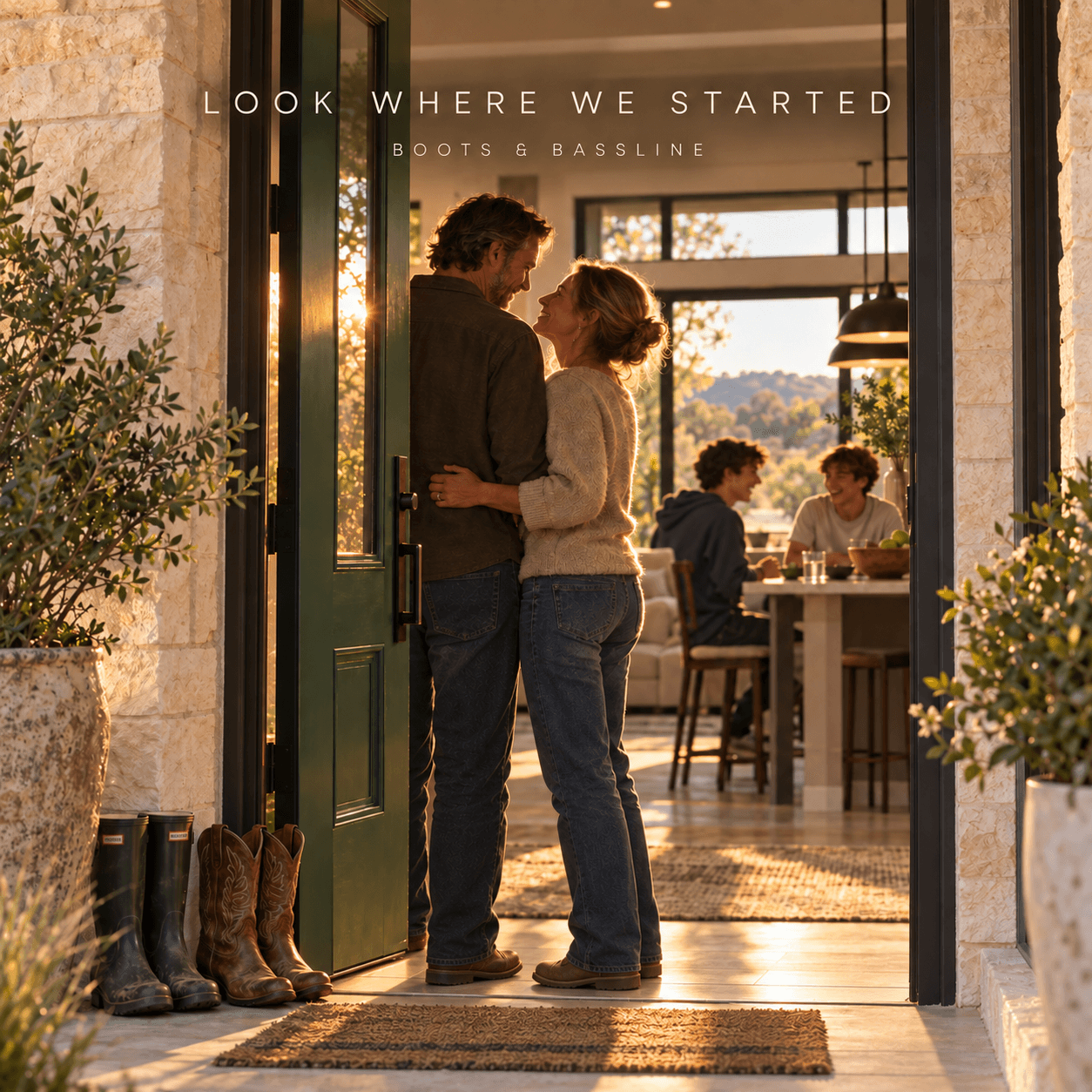 A couple at a green limestone doorway, with two teenage boys inside and wellies and cowboy boots at the threshold.